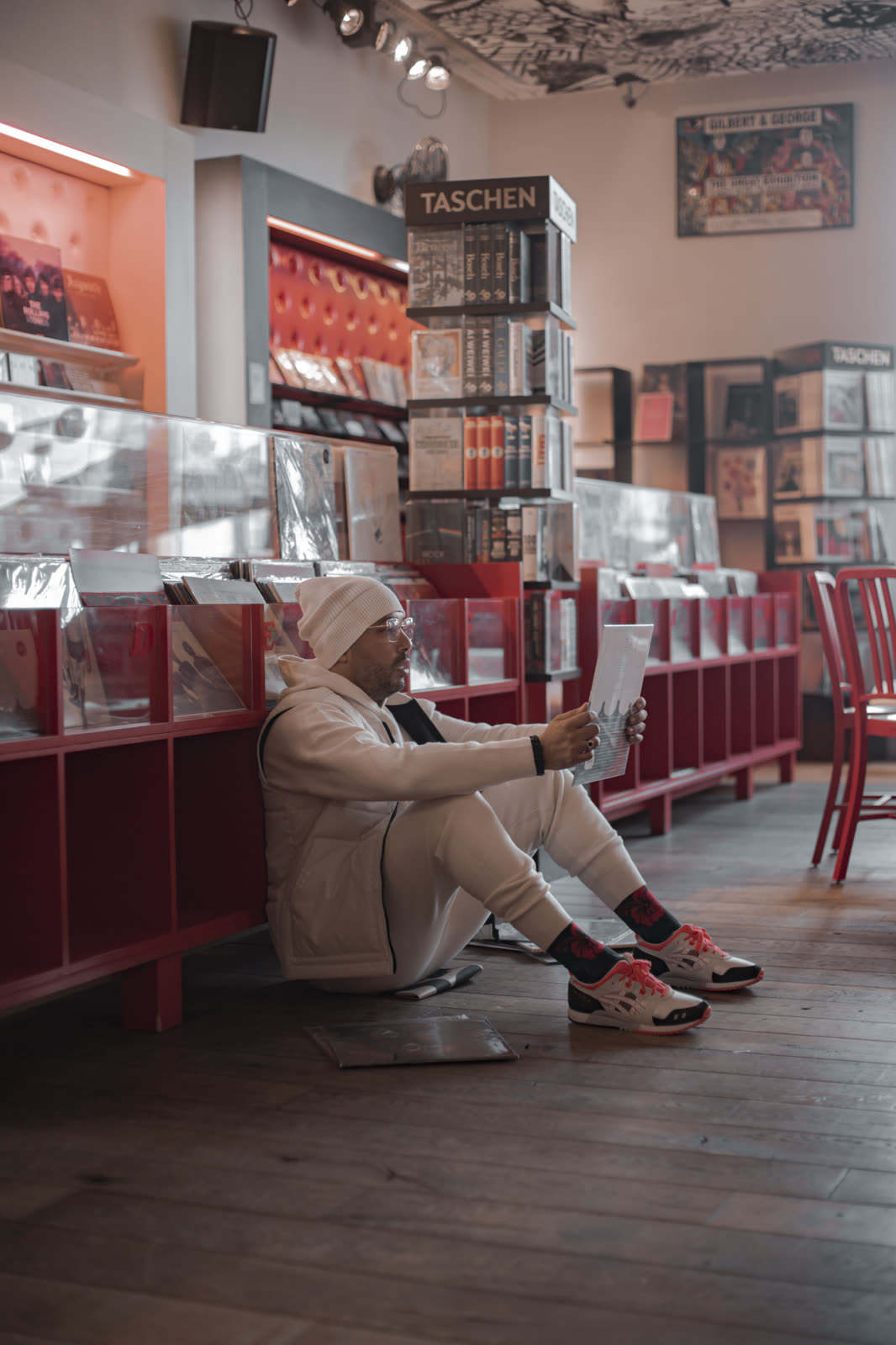 DJ Youcef assis dans un espace intérieur coloré